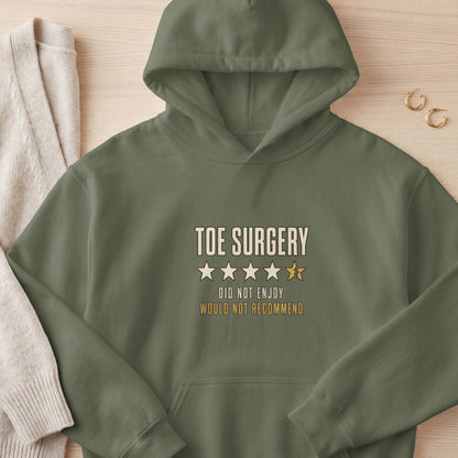 Olive green hoodie with "Toe Surgery," one broken star, and "Did Not Enjoy. Would Not Recommend." text.