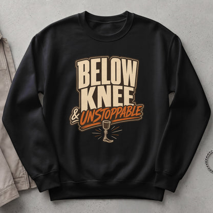 Black sweatshirt with "BELOW KNEE & UNSTOPPABLE" text and prosthetic leg graphic.