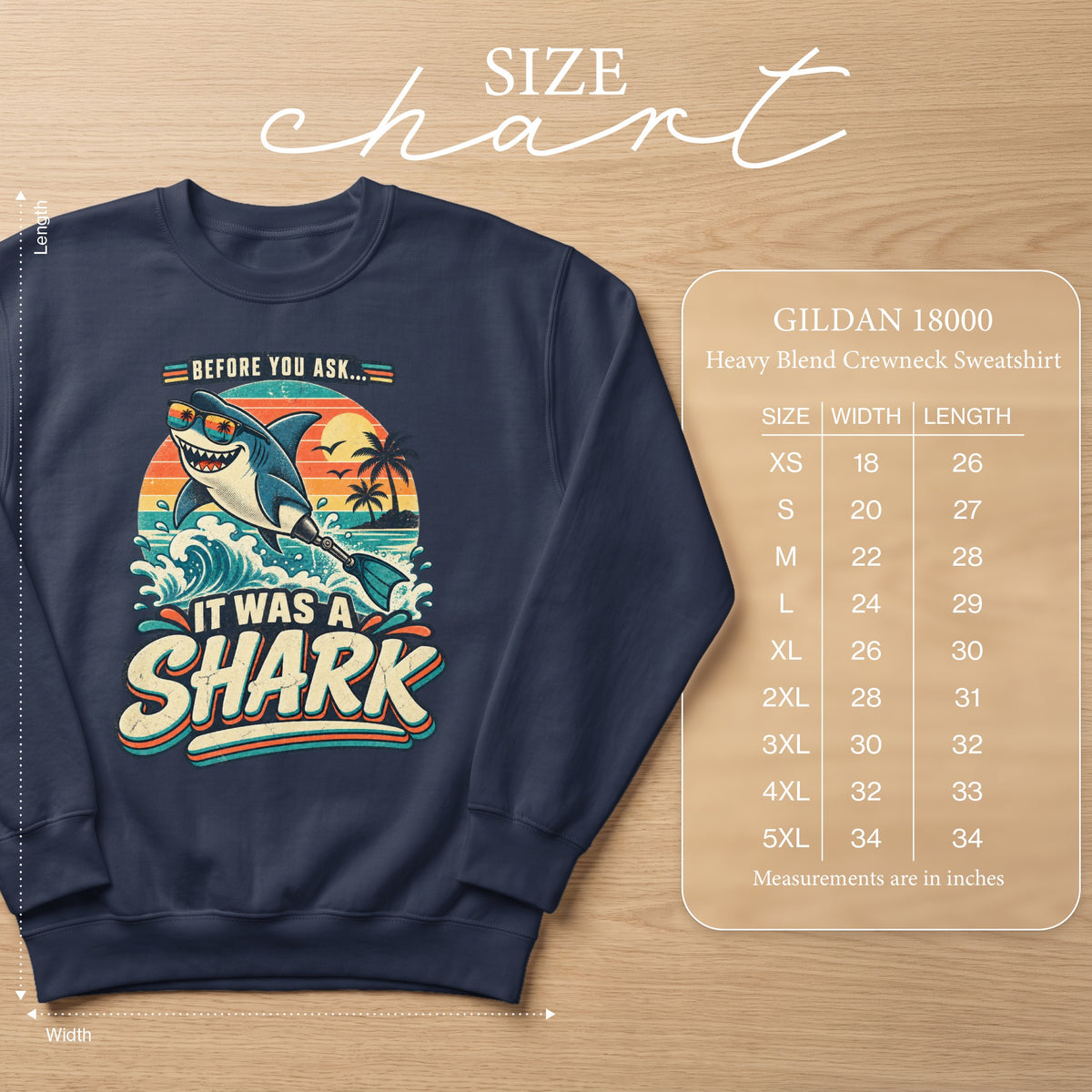 Navy sweatshirt with graphic of shark saying "It Was A Shark" and size chart.