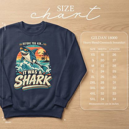 Navy sweatshirt with graphic of shark saying "It Was A Shark" and size chart.