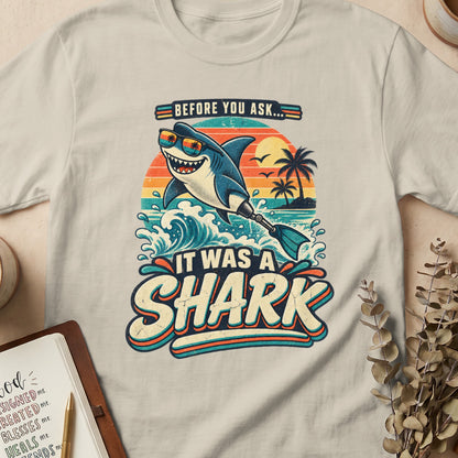 T-shirt graphic with a smiling shark in sunglasses saying "It Was A Shark."