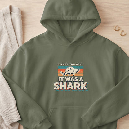 Green hoodie with "Before you ask... It was a shark" graphic.