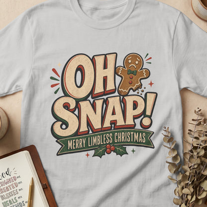 White t-shirt with "OH SNAP! MERRY LIMBLESS CHRISTMAS" and sad gingerbread man graphic.