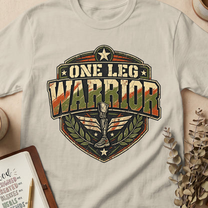 One Leg Warrior emblem with prosthetic leg and laurel wreath on a t-shirt.