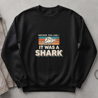 Black sweatshirt with "Before You Ask... It Was A Shark" graphic.