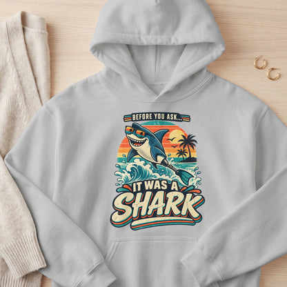 Gray hoodie with "Before You Ask... It Was A Shark" graphic featuring a shark with sunglasses and a flipper.