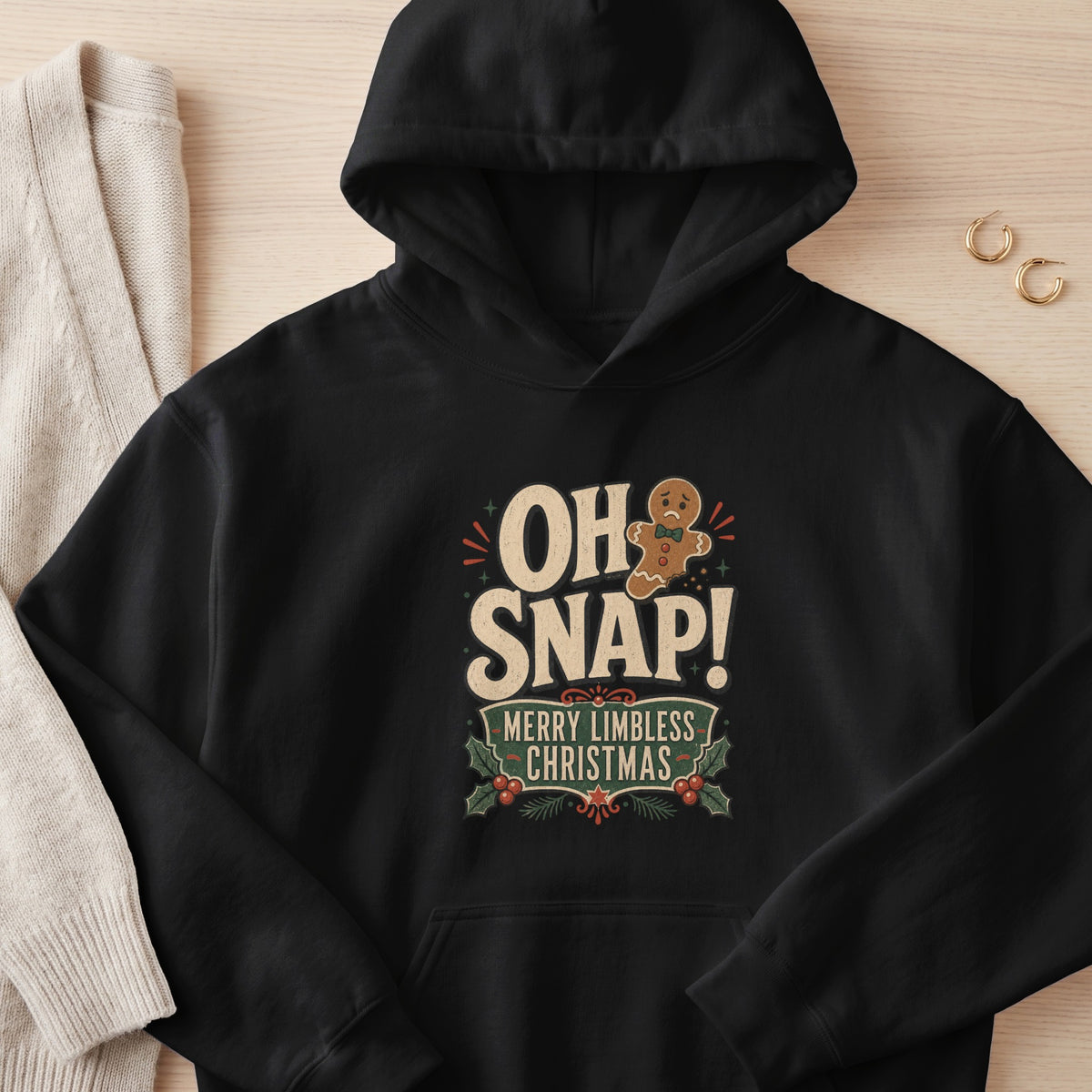 Black hoodie with "OH SNAP! MERRY LIMBLESS CHRISTMAS" text and gingerbread man.
