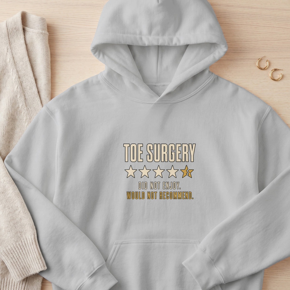 Light gray hoodie with "Toe Surgery" text and a one-star rating.