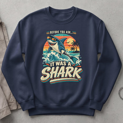"Before you ask... it was a shark" graphic on a navy sweatshirt.