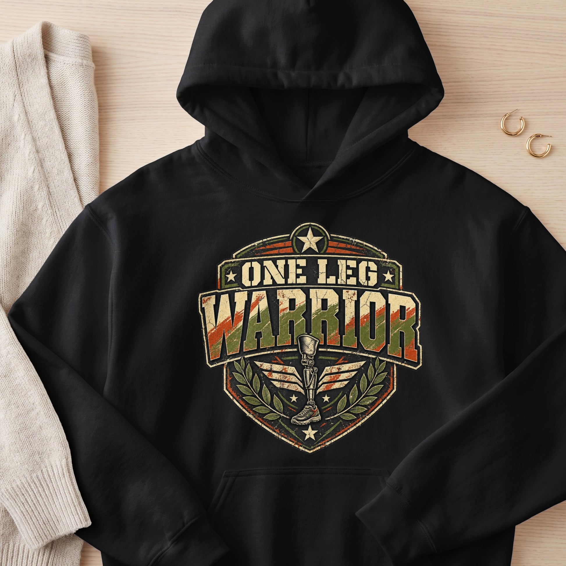 Black hoodie with "ONE LEG WARRIOR" text and a prosthetic leg emblem.