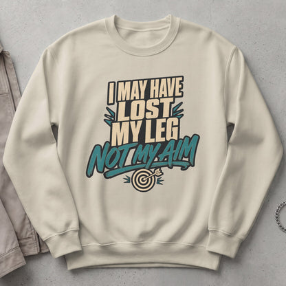 Cream sweatshirt with text "I MAY HAVE LOST MY LEG NOT MY AIM" and a target.