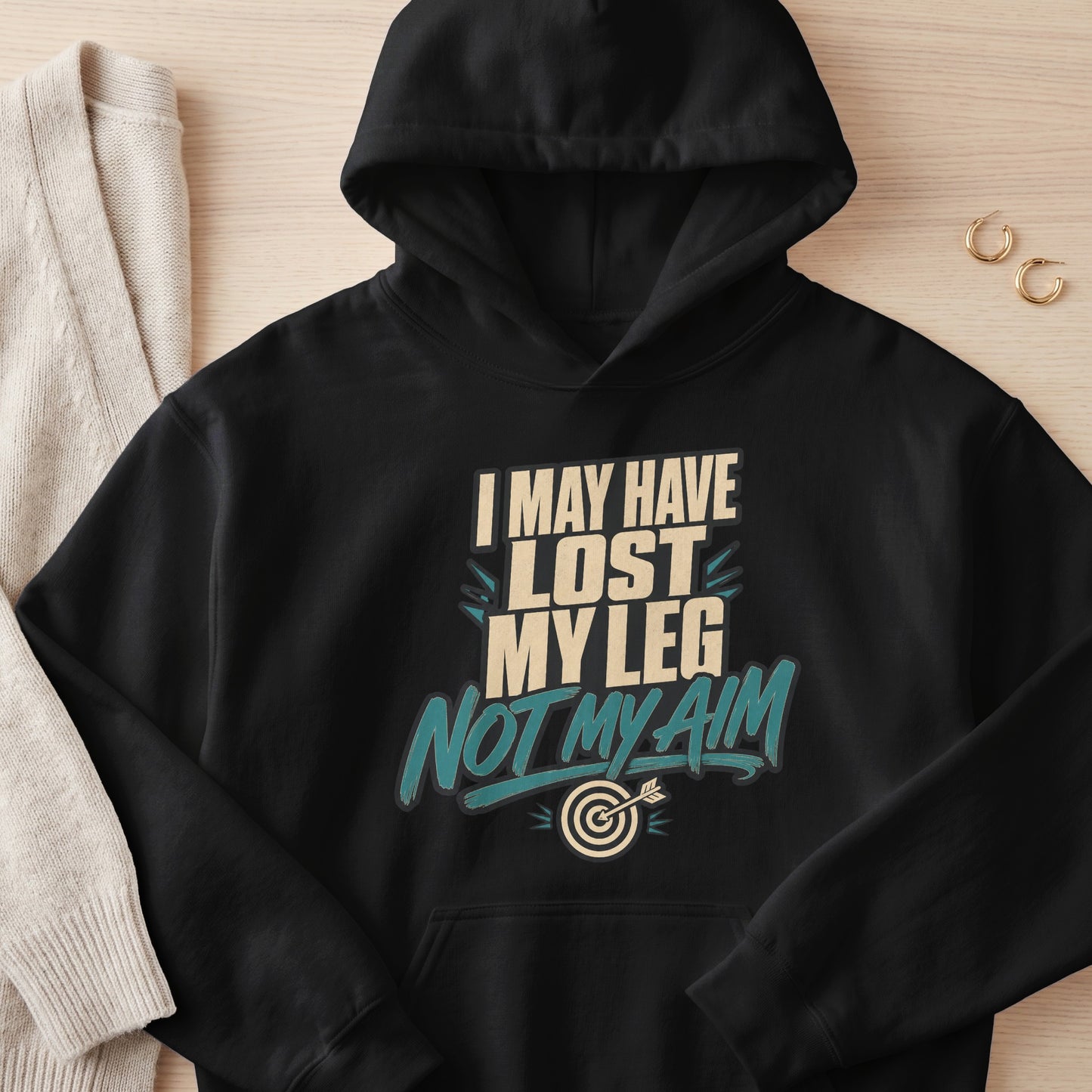 Black hoodie with text "I MAY HAVE LOST MY LEG NOT MY AIM" and a dartboard.