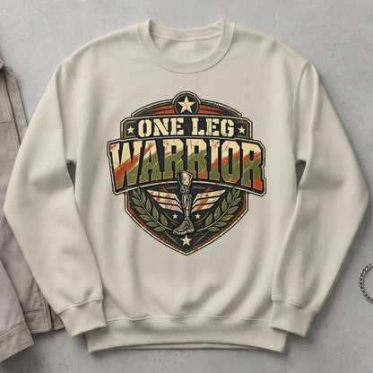 Cream sweatshirt with "One Leg Warrior" crest featuring a prosthetic leg and wings.