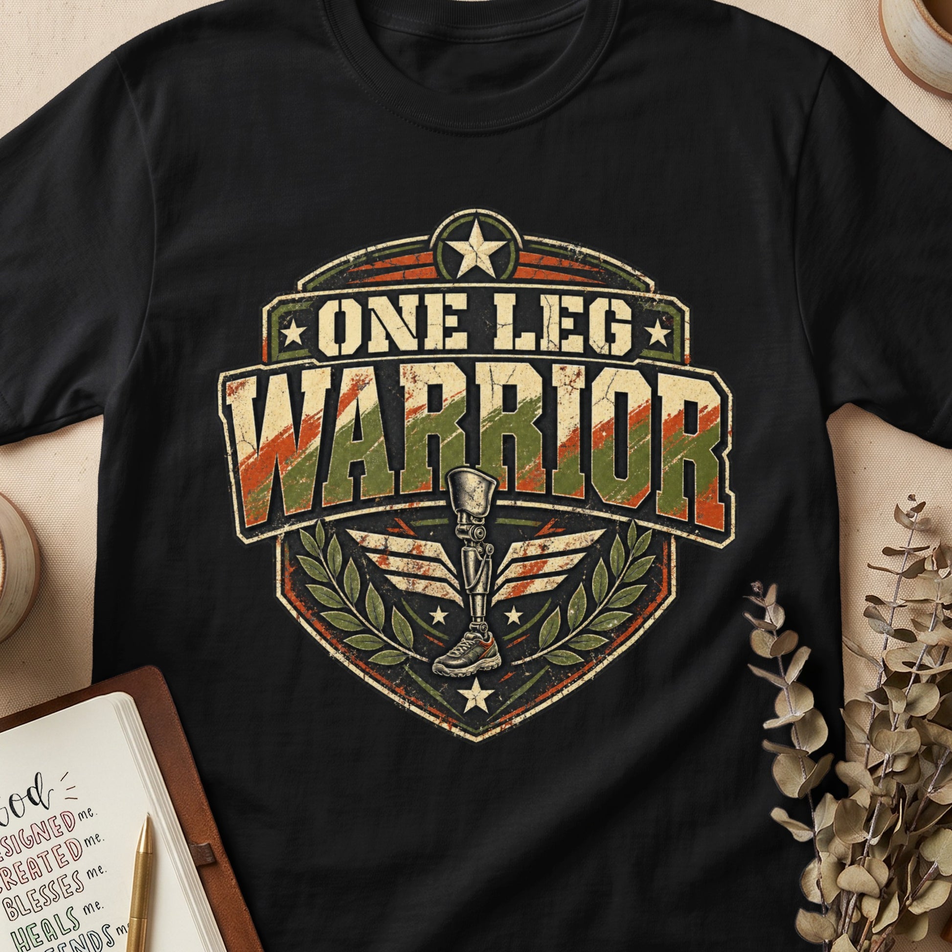 Black t-shirt with "One Leg Warrior" and a prosthetic leg graphic.