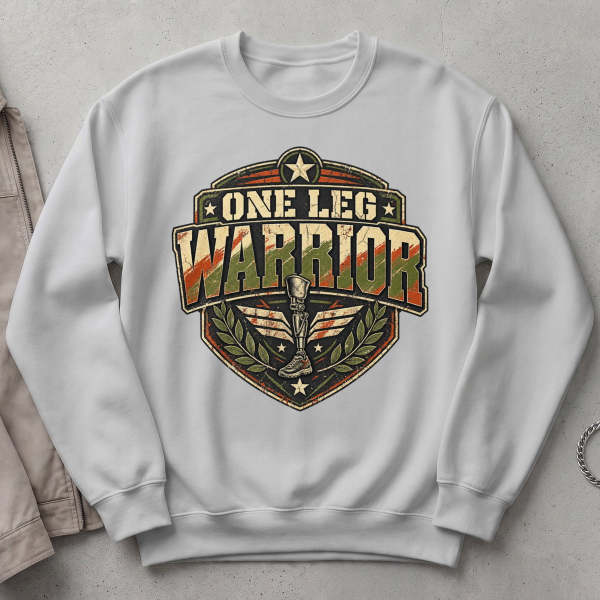 White sweatshirt with "One Leg Warrior" text and a prosthetic leg emblem.