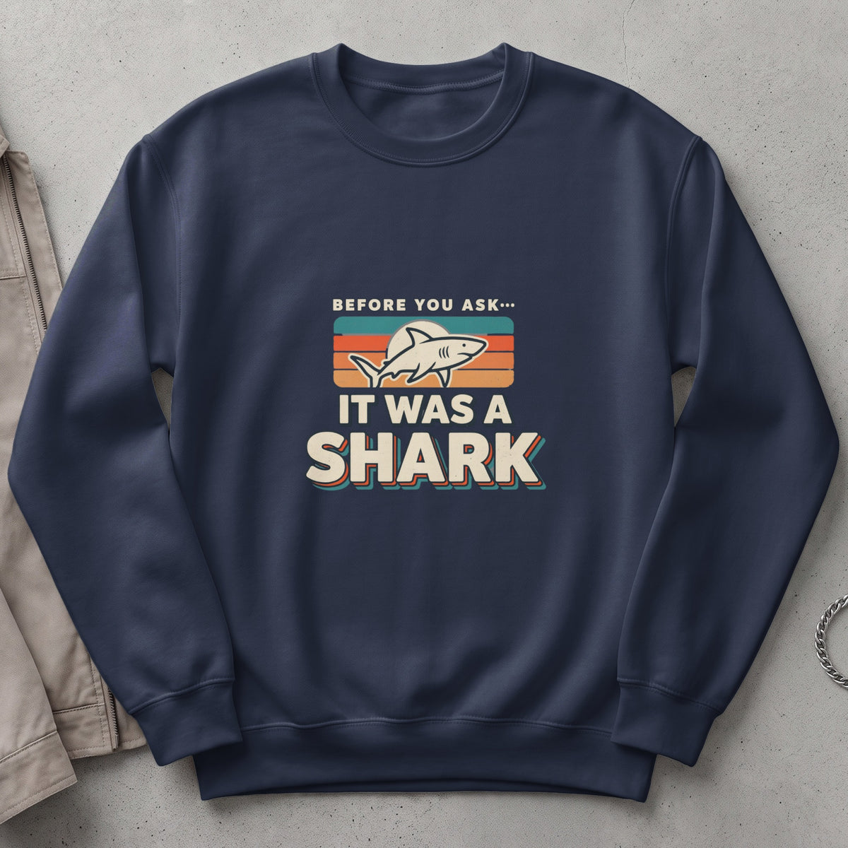 Navy sweatshirt with "Before You Ask... It Was A Shark" graphic.