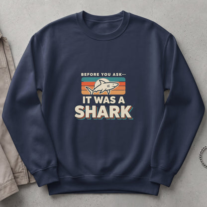 Navy sweatshirt with "Before You Ask... It Was A Shark" graphic.