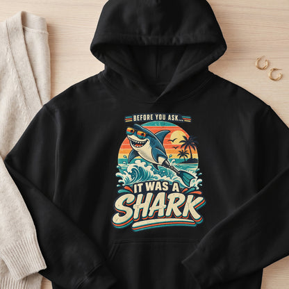 Black hoodie with graphic: "BEFORE YOU ASK... IT WAS A SHARK"