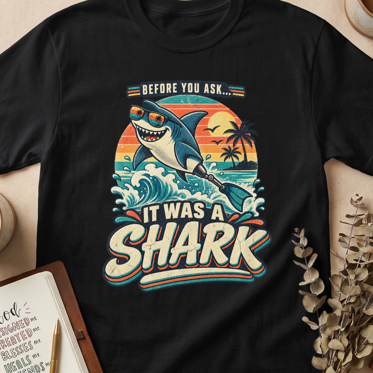 Retro shark with sunglasses on a beach, "It Was A Shark" text.