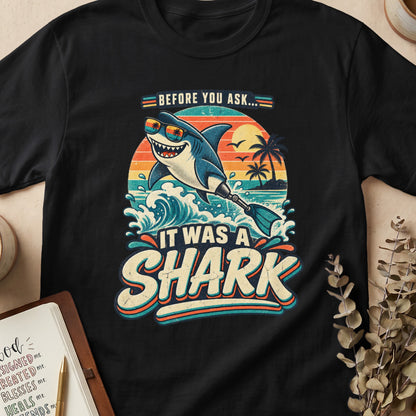 Retro shark with sunglasses on a beach, "It Was A Shark" text.