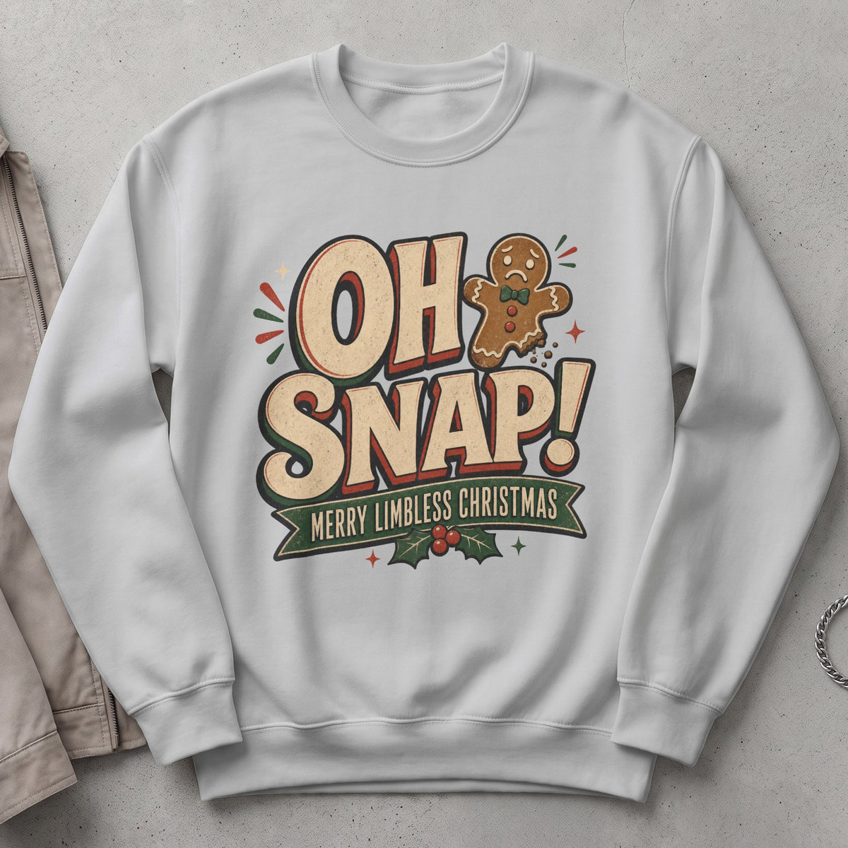 White sweatshirt with "OH SNAP! MERRY LIMBLESS CHRISTMAS" text and sad gingerbread man.