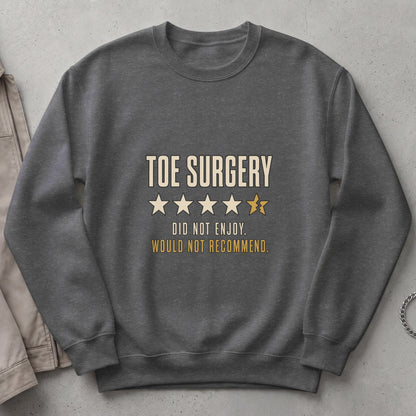 Dark grey sweatshirt with text "TOE SURGERY" and broken star rating.